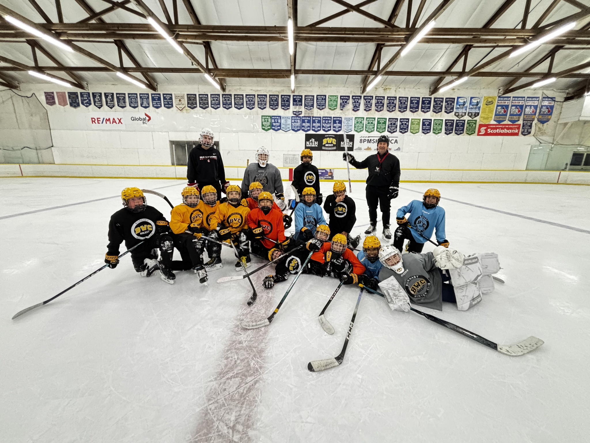 BWC U11 A1 Team with coaches on the ice at Burnaby Winter Club