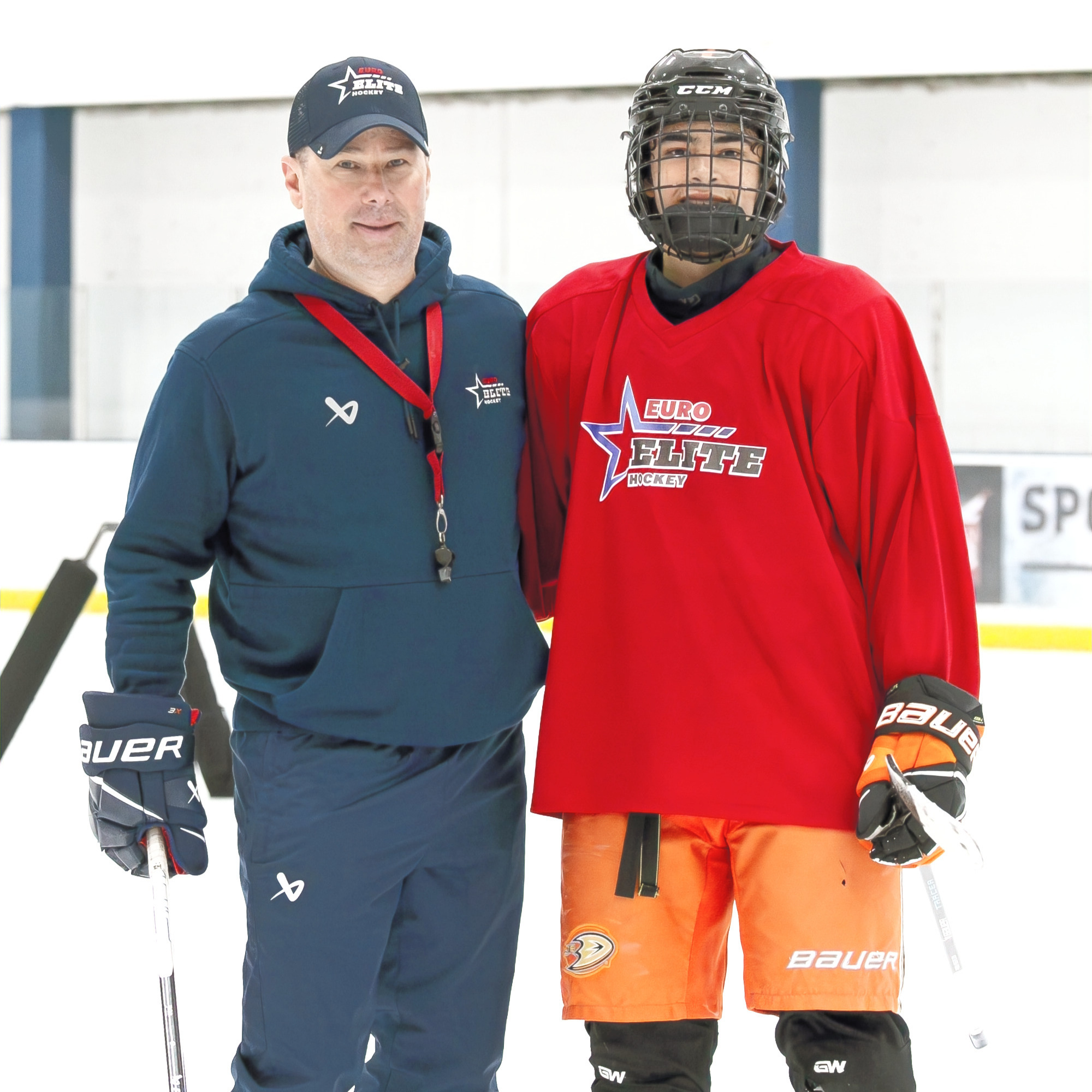 Coach Guido Lamberti-Charles with a player on the ice